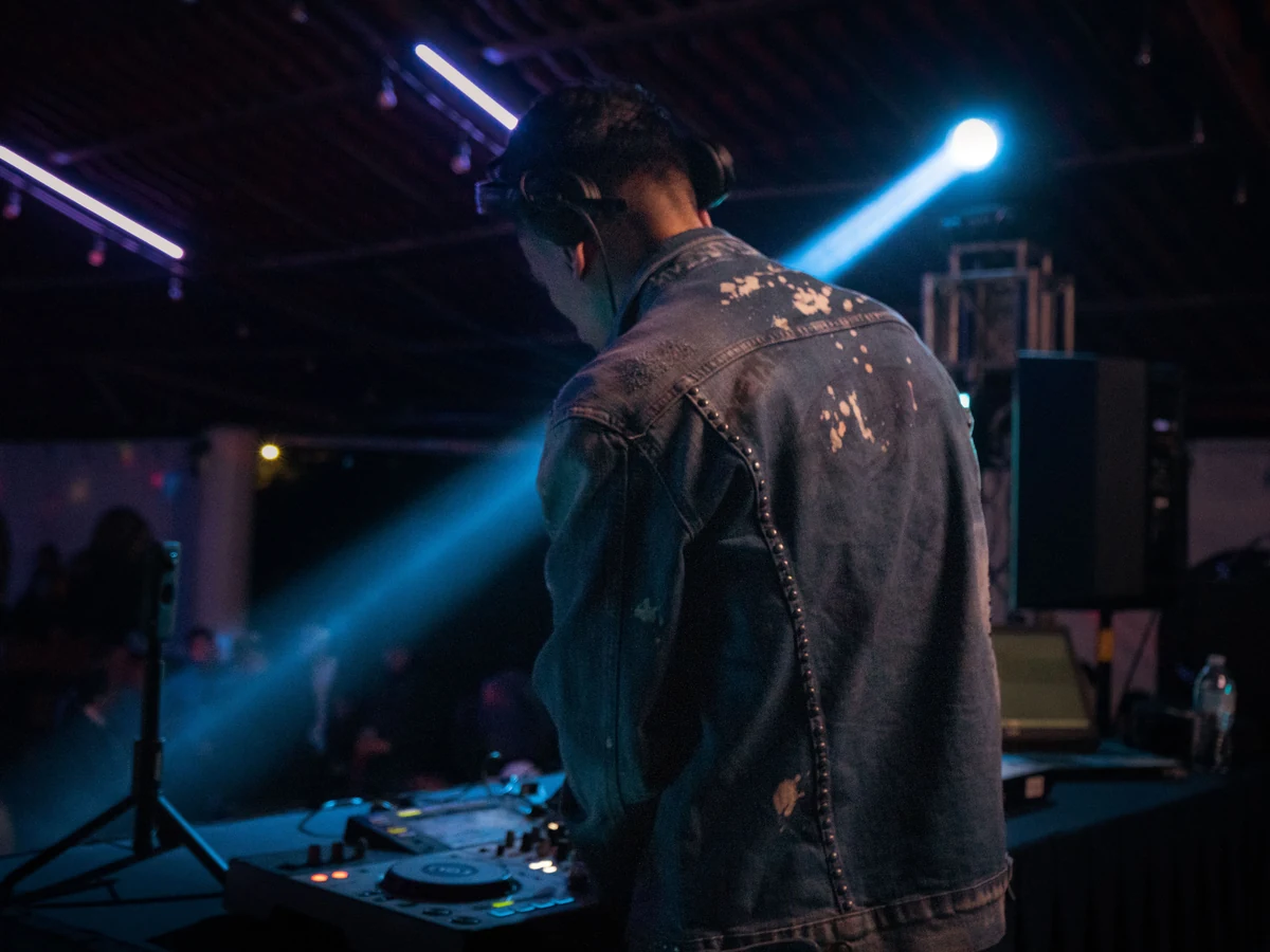 Original photograph of a DJ at a mixing desk